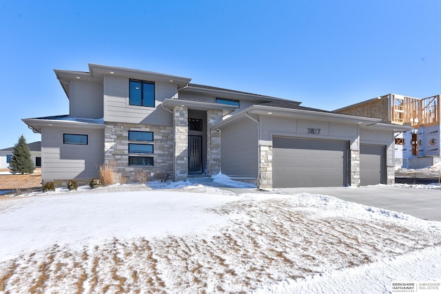 view of front of property with stone siding and an attached garage