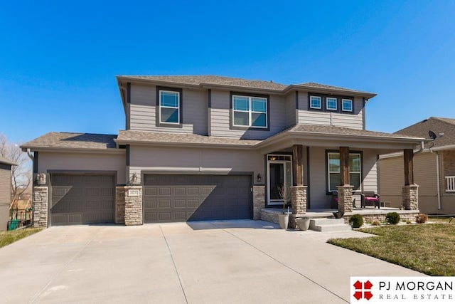 10211 Rosewater Pkwy, Bennington, NE 68007 - prairie-style house featuring driveway, stone siding, a garage, and a porch