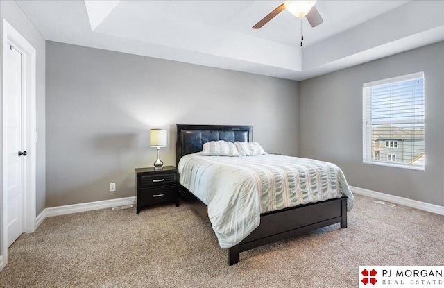 10211 Rosewater Pkwy, Bennington, NE 68007 - bedroom featuring a raised ceiling, visible vents, a ceiling fan, light carpet, and baseboards