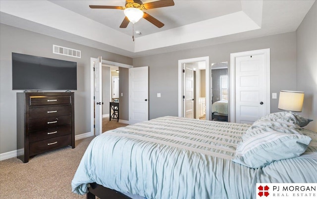 10211 Rosewater Pkwy, Bennington, NE 68007 - bedroom featuring visible vents, baseboards, a ceiling fan, light colored carpet, and a tray ceiling