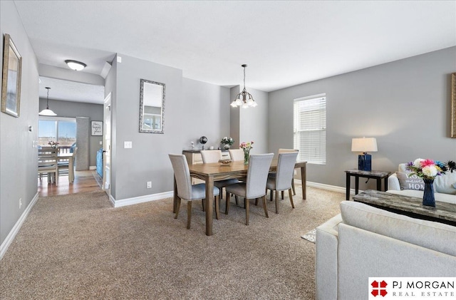 10211 Rosewater Pkwy, Bennington, NE 68007 - carpeted dining space featuring a notable chandelier and baseboards