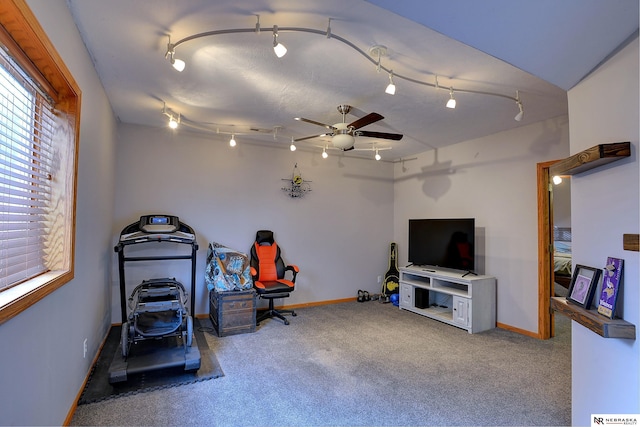 interior space featuring ceiling fan, track lighting, carpet flooring, and baseboards