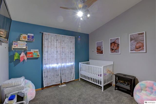 bedroom featuring lofted ceiling, carpet floors, a ceiling fan, baseboards, and a nursery area