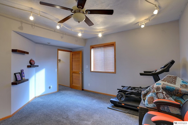 workout area with carpet floors, track lighting, baseboards, and a ceiling fan