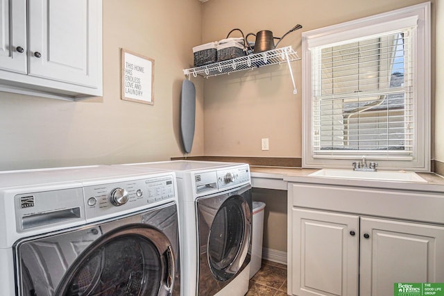 clothes washing area featuring a sink, cabinet space, washing machine and dryer, and tile patterned floors