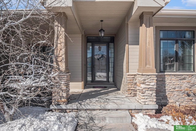 entrance to property featuring stone siding