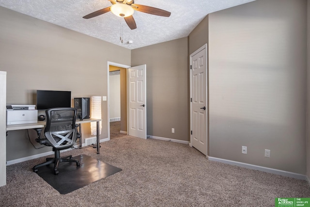 office area with ceiling fan, carpet flooring, baseboards, and a textured ceiling