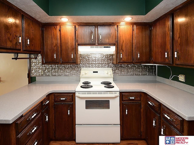 kitchen featuring dark brown cabinetry, white electric stove, decorative backsplash, light countertops, and under cabinet range hood