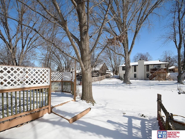 view of yard layered in snow