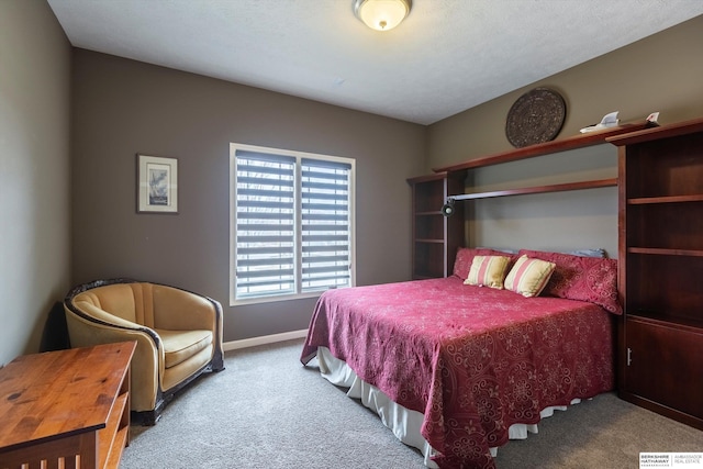 bedroom featuring carpet flooring and baseboards