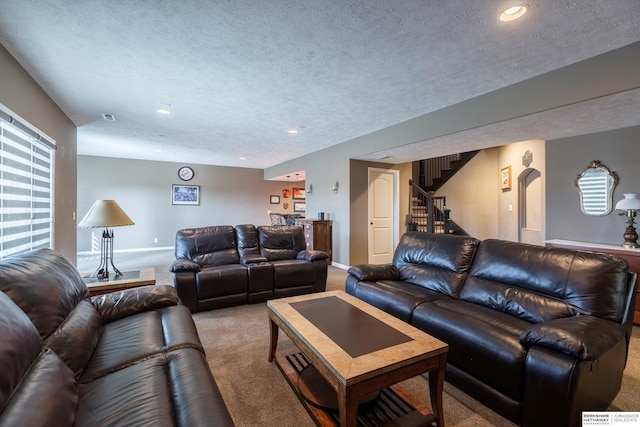 living room with carpet, recessed lighting, a textured ceiling, baseboards, and stairs