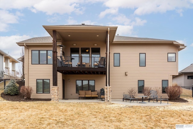 back of house with a lawn, a patio area, fence, and a balcony