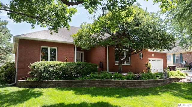 view of front of property with a garage, roof with shingles, brick siding, and a front lawn