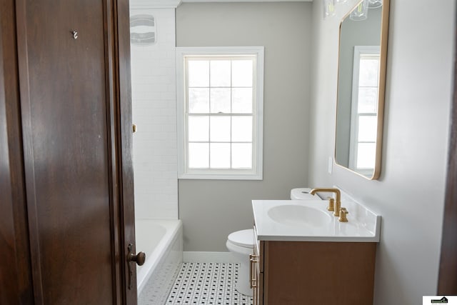 bathroom featuring baseboards, vanity, and toilet