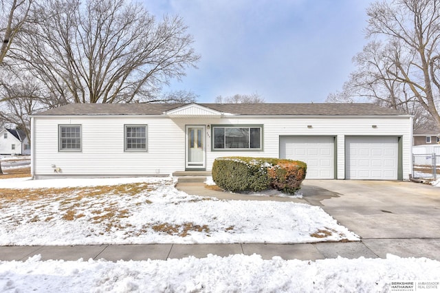 single story home featuring driveway, an attached garage, and fence