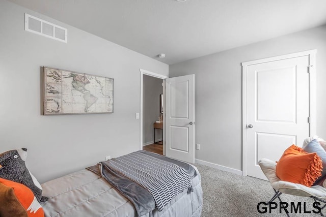 bedroom with carpet floors, baseboards, and visible vents