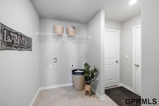 clothes washing area featuring laundry area, baseboards, tile patterned floors, hookup for an electric dryer, and washer hookup