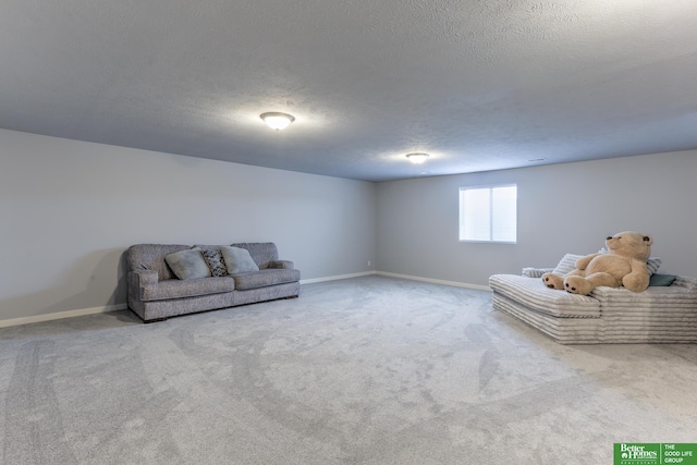 unfurnished living room with carpet, a textured ceiling, and baseboards