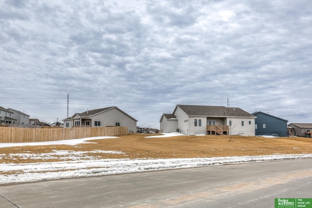 ranch-style home with fence