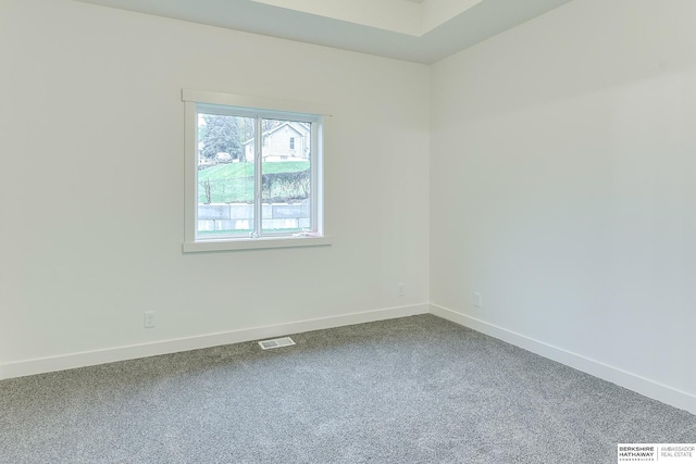 carpeted empty room featuring visible vents and baseboards