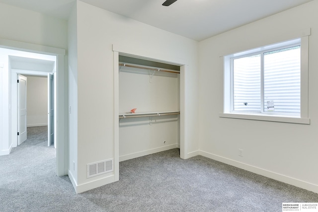 unfurnished bedroom featuring a closet, carpet flooring, visible vents, and baseboards