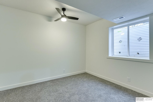 carpeted empty room featuring ceiling fan, visible vents, and baseboards