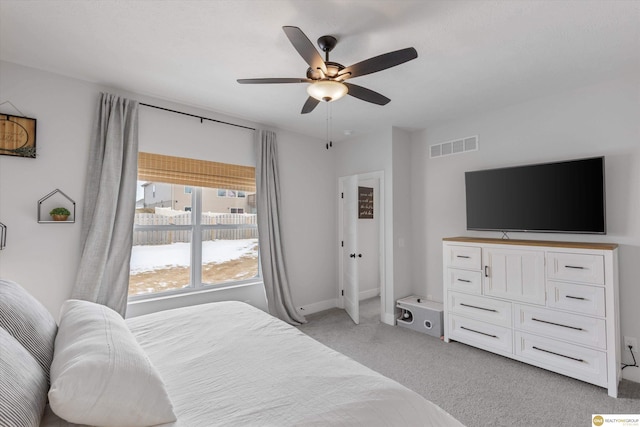 bedroom with light carpet, visible vents, and a ceiling fan