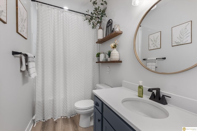 bathroom with a shower with shower curtain, vanity, toilet, and wood finished floors