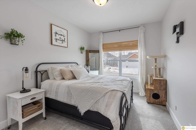 carpeted bedroom with baseboards