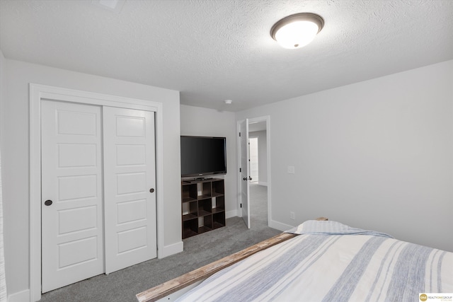 bedroom with carpet floors, a closet, a textured ceiling, and baseboards