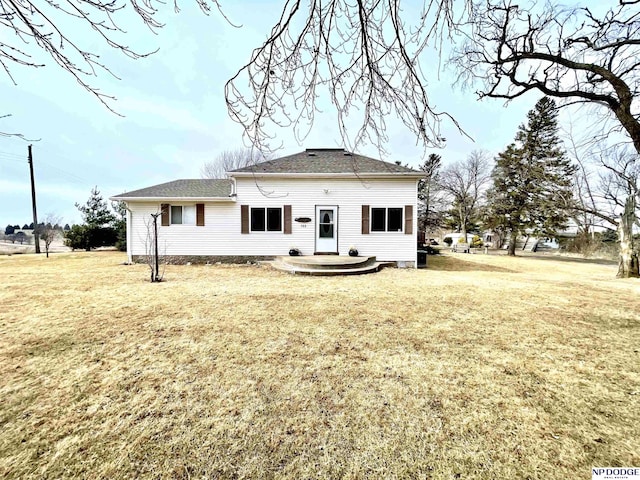 rear view of property with a yard