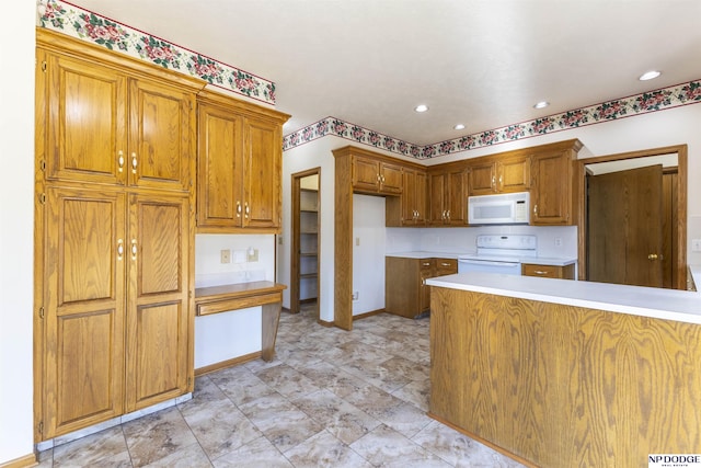 kitchen with brown cabinets, range with electric stovetop, light countertops, white microwave, and baseboards