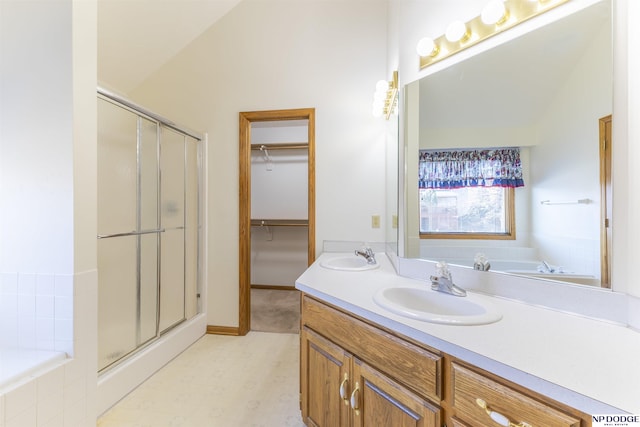 bathroom featuring vaulted ceiling, a sink, and a shower stall