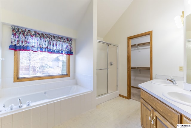 bathroom featuring lofted ceiling, a sink, a garden tub, and a shower stall