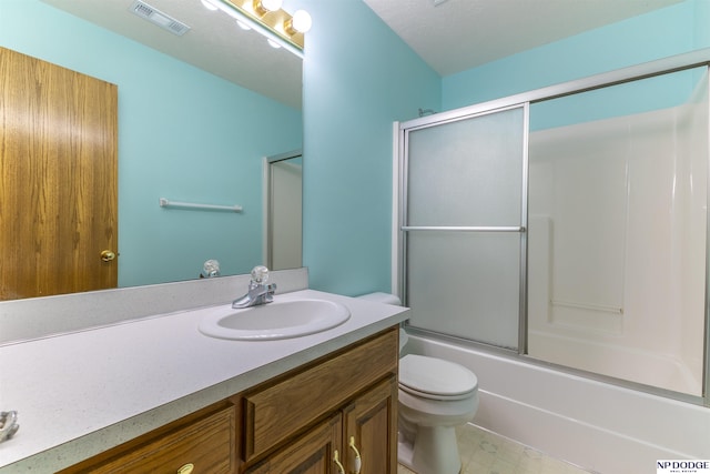 full bathroom featuring toilet, enclosed tub / shower combo, visible vents, and vanity