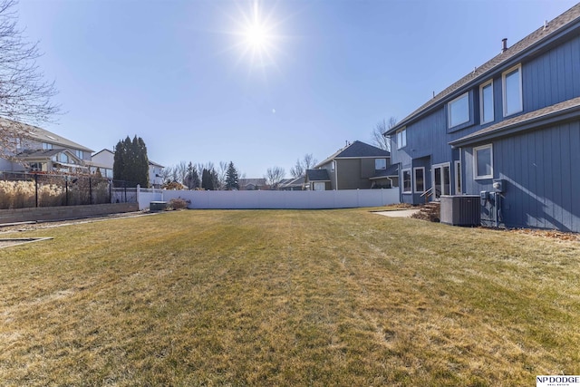 view of yard featuring fence and cooling unit