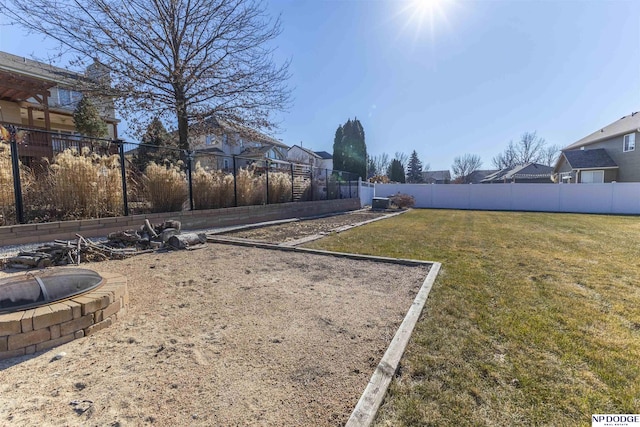 view of yard featuring a fenced backyard and a residential view