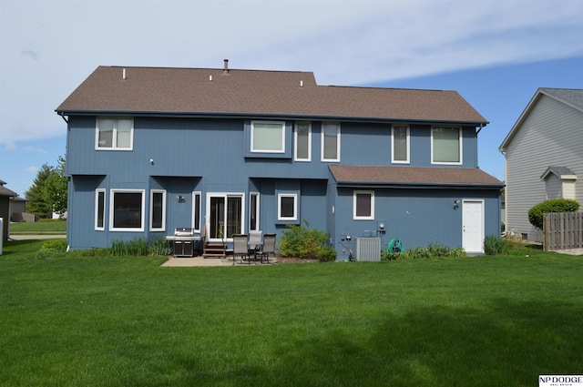 rear view of house featuring a yard, central AC unit, and a patio area