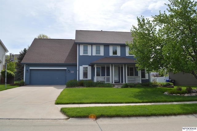 view of front of house featuring a shingled roof, covered porch, a front yard, a garage, and driveway