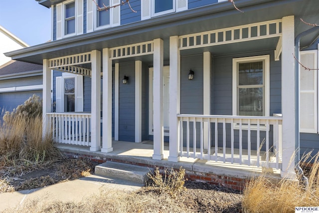 property entrance with covered porch and an attached garage