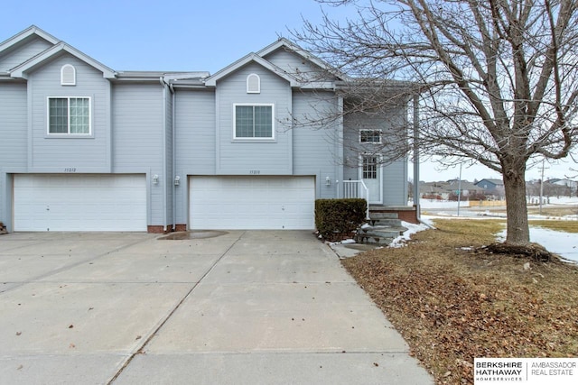 view of front of property with concrete driveway and an attached garage