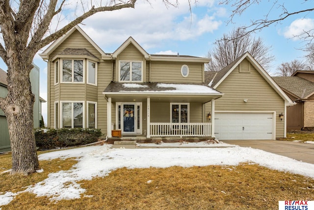 traditional-style home with a garage, concrete driveway, and a porch