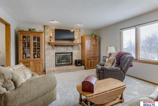 carpeted living area with a fireplace, a textured ceiling, and baseboards