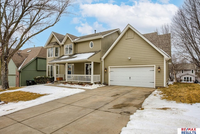 traditional-style home featuring driveway, a porch, an attached garage, and a shingled roof