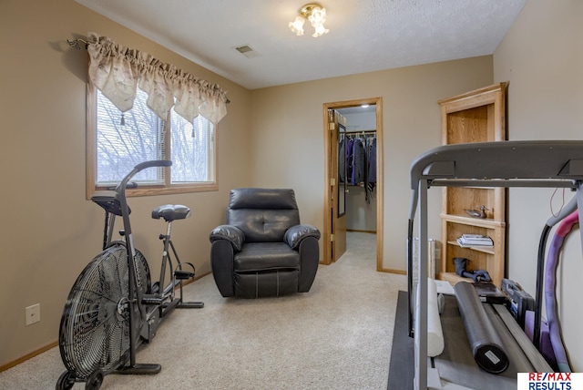 exercise area featuring carpet flooring, visible vents, and baseboards