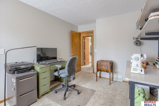 office area with light carpet, visible vents, baseboards, and a textured ceiling