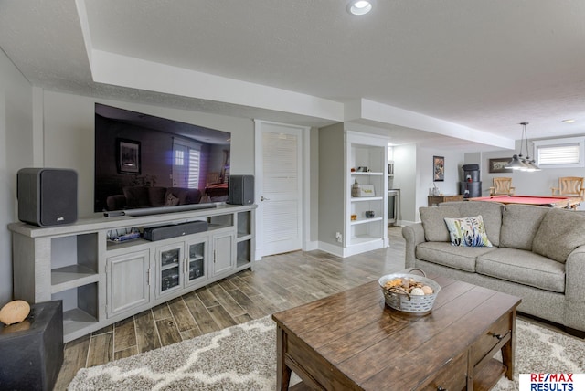 living room featuring light wood-type flooring and baseboards