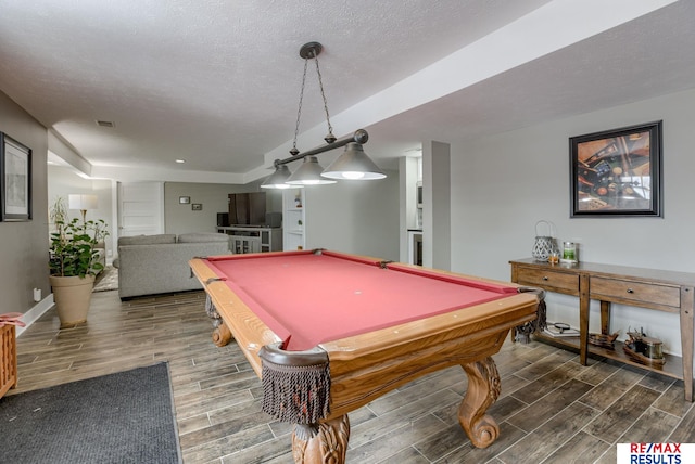 recreation room featuring wood tiled floor, pool table, a textured ceiling, and baseboards