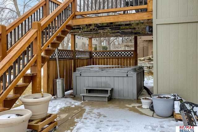 view of patio / terrace featuring a hot tub and stairway