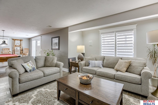 living area with a textured ceiling, visible vents, wood finished floors, and pool table